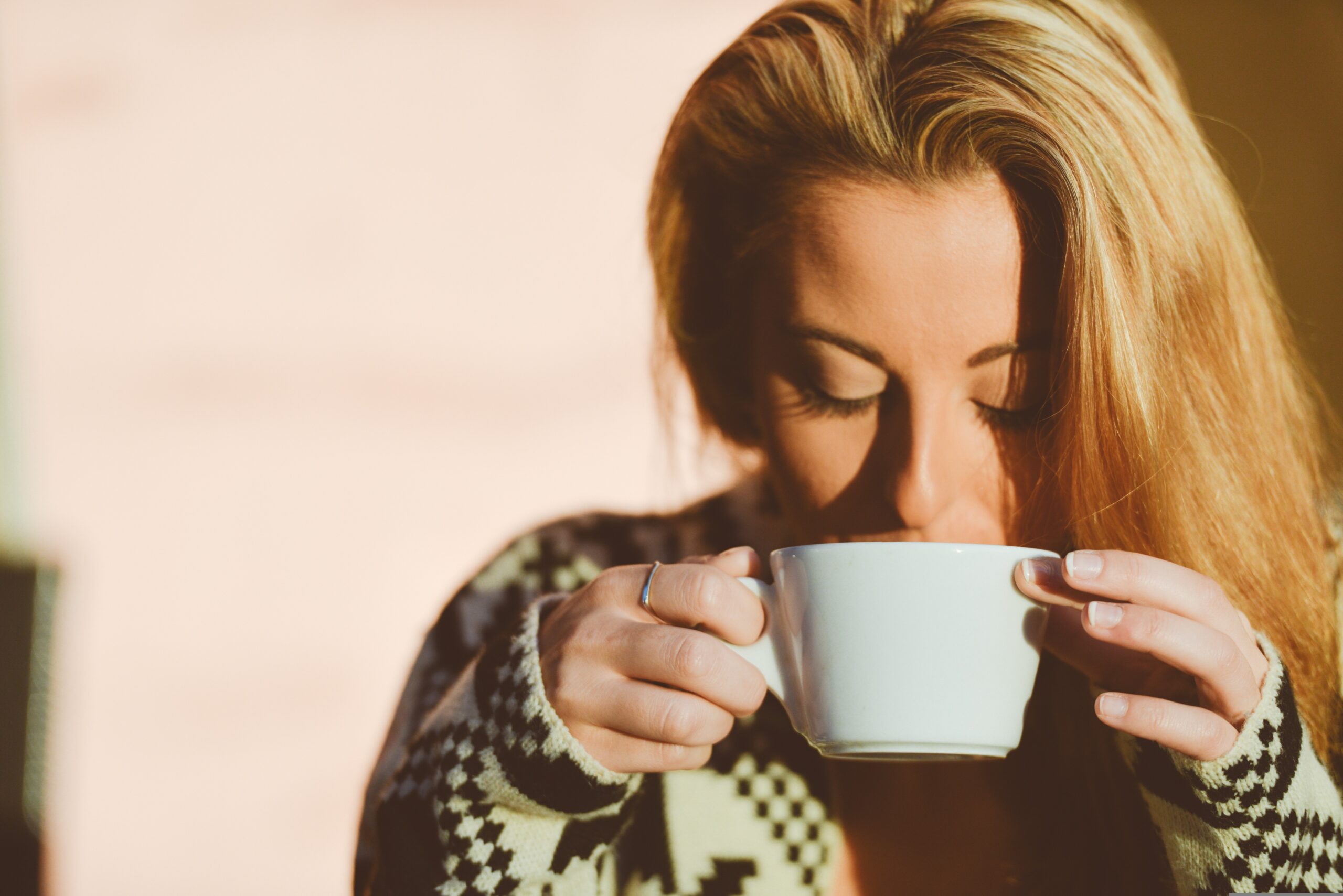 Frau trinkt Kuzu aus einer Tasse und genießt Frau trinkt Kuzu aus einer Tasse und genießt